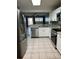 Updated kitchen showcasing stainless steel appliances and updated granite counters at 7802 Hardwick Dr # 1116, New Port Richey, FL 34653