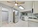 Open kitchen featuring stainless steel appliances, white cabinets, granite countertops, and backyard access at 7802 Hardwick Dr # 1116, New Port Richey, FL 34653