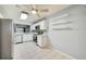 Updated kitchen featuring white cabinets, stainless steel appliances, granite counters, and tile flooring at 7802 Hardwick Dr # 1116, New Port Richey, FL 34653