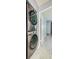Laundry area with modern, stacked washer and dryer units and a view to a bedroom at 7802 Hardwick Dr # 1116, New Port Richey, FL 34653