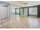 Bright living area featuring wood-look floors, modern ceiling fan, and access to two separate entryways at 7802 Hardwick Dr # 1116, New Port Richey, FL 34653