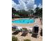 Community swimming pool with lounge chairs, offering a relaxing space for residents at 7802 Hardwick Dr # 1116, New Port Richey, FL 34653