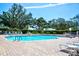 Enjoy the beautiful community pool surrounded by lush landscaping, chairs and tables for relaxing at 7802 Hardwick Dr # 1116, New Port Richey, FL 34653