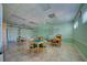 Well-lit community room with game tables, tile flooring, and ample space for activities at 7802 Hardwick Dr # 1116, New Port Richey, FL 34653