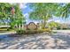 View of the Millpond Trace community entrance sign, lined with shrubs, flowers, and green spaces at 7802 Hardwick Dr # 1116, New Port Richey, FL 34653