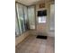 Bright sunroom with tile floors, window blinds, and a door leading to the outside at 7802 Hardwick Dr # 1116, New Port Richey, FL 34653
