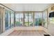 Bright sunroom with tiled floor and large windows overlooking lush landscaping at 7802 Hardwick Dr # 1116, New Port Richey, FL 34653