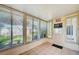 Enclosed sunroom with multiple windows and tile flooring, providing a bright and airy space at 7802 Hardwick Dr # 1116, New Port Richey, FL 34653