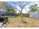 Fenced backyard with screened pool and utility shed at 7810 Chalafonte Dr, Port Richey, FL 34668