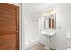 Bathroom featuring a pedestal sink, standing shower, and shuttered door at 7810 Chalafonte Dr, Port Richey, FL 34668