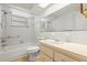 Bathroom with tub, white tile surround, and updated vanity with storage at 7810 Chalafonte Dr, Port Richey, FL 34668