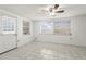 Bright bedroom with tile floors, ceiling fan, and natural light at 7810 Chalafonte Dr, Port Richey, FL 34668