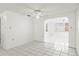 Bright dining room with tile floors and open archway leading into living room at 7810 Chalafonte Dr, Port Richey, FL 34668