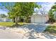 View of the house with an attached garage and long driveway at 7810 Chalafonte Dr, Port Richey, FL 34668
