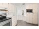 Bright kitchen with a stainless steel range and built-in microwave oven at 7810 Chalafonte Dr, Port Richey, FL 34668