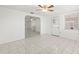 Open-concept living room with tile floors and a ceiling fan at 7810 Chalafonte Dr, Port Richey, FL 34668
