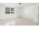 Bright living room with tile floors, a large window, and a simple, clean design at 7810 Chalafonte Dr, Port Richey, FL 34668