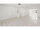 Bright living room with tile floors, a large window, and an open layout into the dining area at 7810 Chalafonte Dr, Port Richey, FL 34668