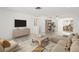 Staged living room with tile flooring, a large window, and an open layout into the dining area at 7810 Chalafonte Dr, Port Richey, FL 34668