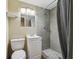 Modern bathroom featuring white vanity and shower with gray tile and stone flooring at 7830 Ilex Dr, Port Richey, FL 34668