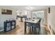 View of the dining area adjacent to the kitchen with wood-look floors and natural lighting at 7830 Ilex Dr, Port Richey, FL 34668