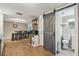Stylish kitchen featuring tile flooring and a barn door that leads to a bathroom at 7830 Ilex Dr, Port Richey, FL 34668
