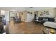 Spacious living room with wood-look floors, dining area and comfortable seating arrangement at 7830 Ilex Dr, Port Richey, FL 34668