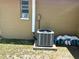 Exterior shot of the AC unit, window, and other utility components on a home's side at 7861 Raintree Dr, New Port Richey, FL 34653