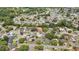 Explore this home's neighborhood from an aerial view, revealing its place within a community of tree-lined streets at 7861 Raintree Dr, New Port Richey, FL 34653