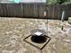 Fenced backyard featuring a fire pit and bird feeder at 7861 Raintree Dr, New Port Richey, FL 34653