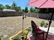 Fenced backyard with patio featuring outdoor seating and potted plants at 7861 Raintree Dr, New Port Richey, FL 34653