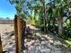 Landscaped backyard with established trees and privacy fence at 7861 Raintree Dr, New Port Richey, FL 34653