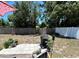 Backyard with patio, privacy fence, and mature trees at 7861 Raintree Dr, New Port Richey, FL 34653