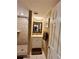 Bathroom with updated vanity and mirror; shower has tiled surround at 7861 Raintree Dr, New Port Richey, FL 34653