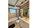 Well-maintained bathroom with shower-tub combo and modern vanity at 7861 Raintree Dr, New Port Richey, FL 34653