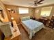 Inviting bedroom with ceiling fan, natural lighting, and patterned comforter at 7861 Raintree Dr, New Port Richey, FL 34653