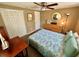 Bright bedroom with closet, neutral decor, and wooden dresser at 7861 Raintree Dr, New Port Richey, FL 34653