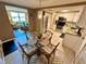 Charming dining area adjacent to kitchen featuring glass table and easy access to living room at 7861 Raintree Dr, New Port Richey, FL 34653