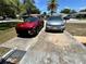 Driveway featuring a red SUV and a silver minivan at 7861 Raintree Dr, New Port Richey, FL 34653