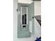 An open electrical panel with the breaker switches are installed on the garage wall at 7861 Raintree Dr, New Port Richey, FL 34653