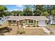 Inviting single-story home with a well-kept front yard, complemented by a driveway and attached garage at 7861 Raintree Dr, New Port Richey, FL 34653