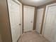 Hallway with access to storage closets and bedrooms at 7861 Raintree Dr, New Port Richey, FL 34653