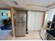 Well-equipped kitchen with stainless steel refrigerator and convenient access to other living spaces at 7861 Raintree Dr, New Port Richey, FL 34653