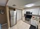 Bright kitchen featuring stainless steel appliances, granite countertops and tile flooring at 7861 Raintree Dr, New Port Richey, FL 34653