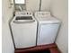 Laundry area featuring new white washer and dryer units inside the house at 7861 Raintree Dr, New Port Richey, FL 34653
