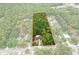Aerial view of property with expansive lot surrounded by lush greenery and mature trees at 8102 Fort Dade Ave, Brooksville, FL 34601