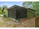 Exterior view of a screened-in porch, enhancing outdoor living space of the home at 8102 Fort Dade Ave, Brooksville, FL 34601