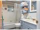 Charming bathroom with a shower-tub combination, gray vanity, and ample storage at 8102 Fort Dade Ave, Brooksville, FL 34601