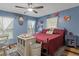 Comfortable bedroom featuring a full bed, natural light, and vintage decor at 8102 Fort Dade Ave, Brooksville, FL 34601