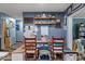 Dining area with a long wooden table and a mix of chairs and bench seating at 8102 Fort Dade Ave, Brooksville, FL 34601